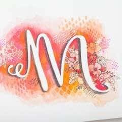 the letter m is painted with watercolors and then it has flowers on it