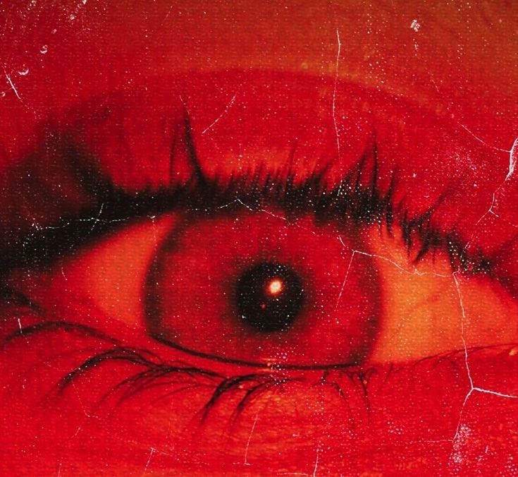 an eye is shown with red paint on it