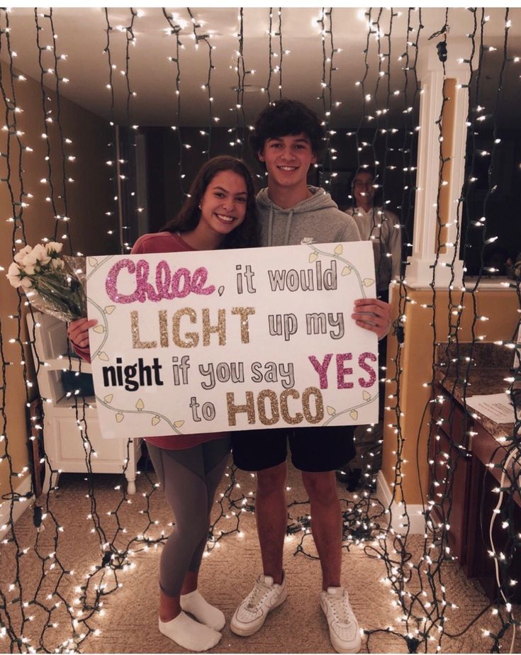 two people are holding a sign that says, close it would light up my night if you say yes to hoo