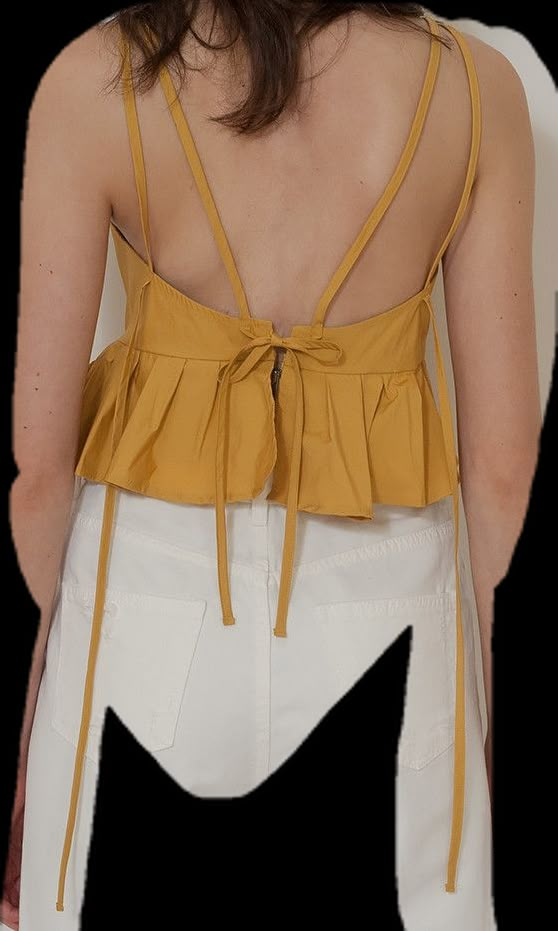 the back of a woman wearing a yellow top