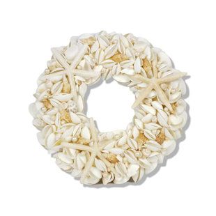 a wreath made out of shells on a white background