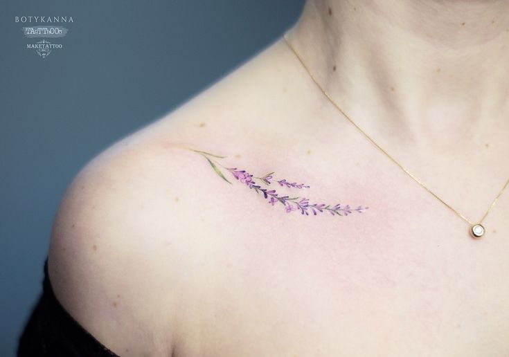 a woman's chest with a flower tattoo on it