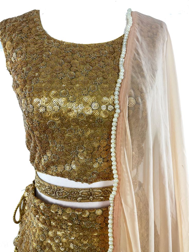 This GORGEOUS lehenga is all hands on deck! This 3-piece gold lehenga is covered in glittering gold embroidery and comes with a stunning pale pink dupatta with pearls and gold stones around the border. *belt available upon request. Shimmer Lehenga, Gorgeous Lehenga, Mens Indian Wear, Gold Lehenga, Pink Dupatta, Western Wear Dresses, Half Saree Designs, Matching Jewelry, Gold Embroidery