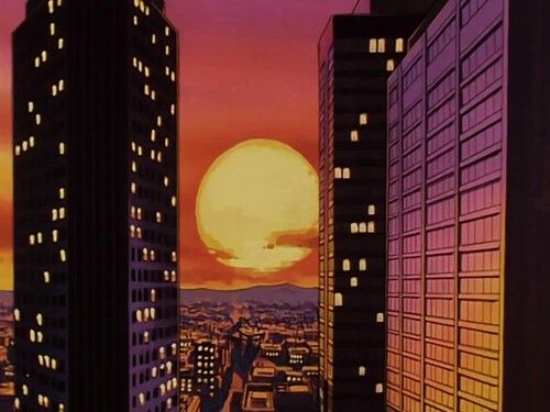 the sun is setting behind some tall buildings