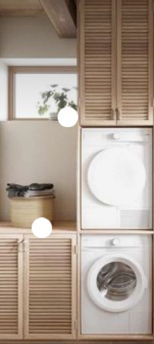 a washer and dryer in a room with wood paneling on the walls