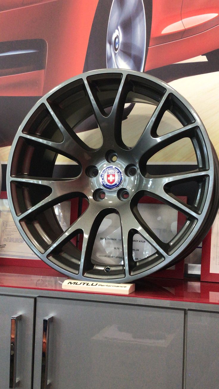 a wheel on display in a showroom for people to see and do something else