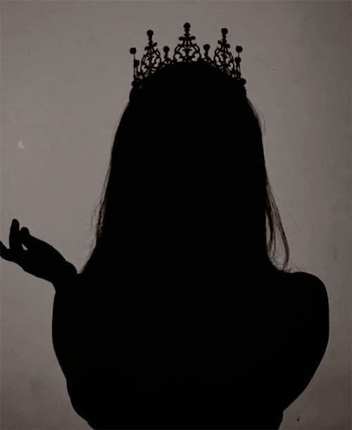 the silhouette of a woman with a crown on her head