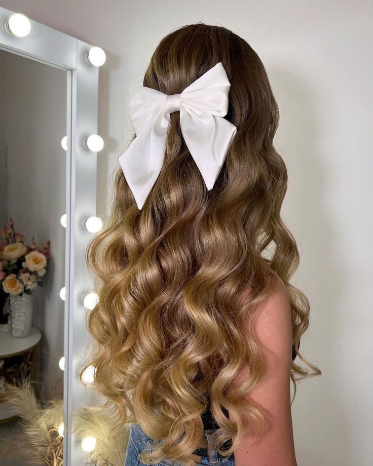 This half-up, half-down hairstyle features voluminous, soft curls with a large white bow, adding a playful yet elegant touch. The bow enhances the femininity of the style, making it perfect for romantic dates or festive celebrations. Half Up Half Down Curled, Soft Curl Hairstyles, Cute Curly Hairstyles, Winter Event, Bow Hairstyle, Half Updo, Bow Making, Soft Curls, Romantic Dates