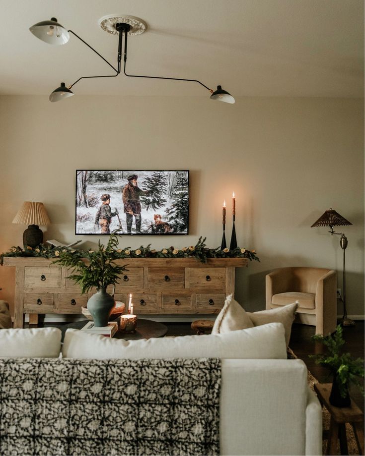 a living room filled with furniture and a flat screen tv mounted to the side of a wall