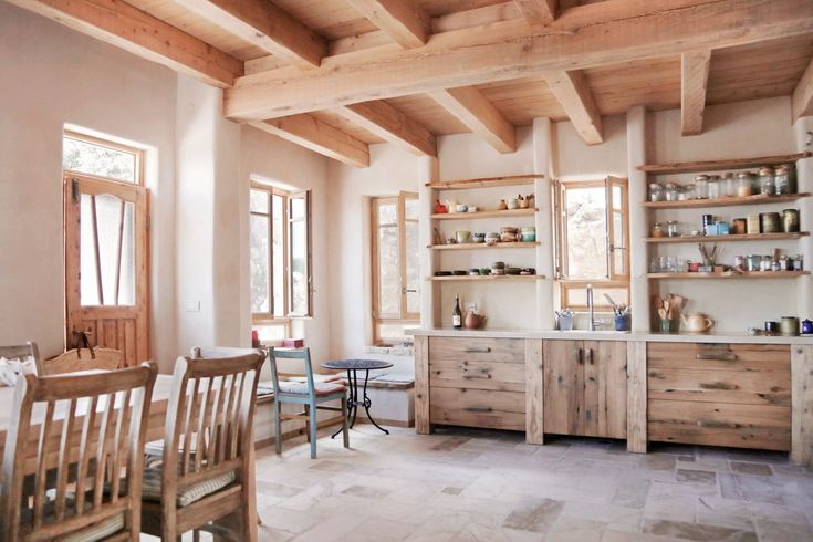 a dining room with wooden furniture and open shelves