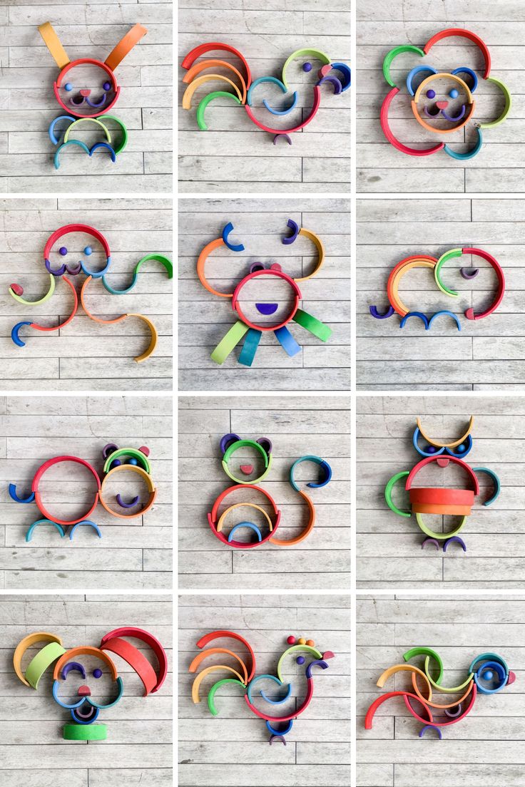 several different colored paper sculptures on a white brick wall