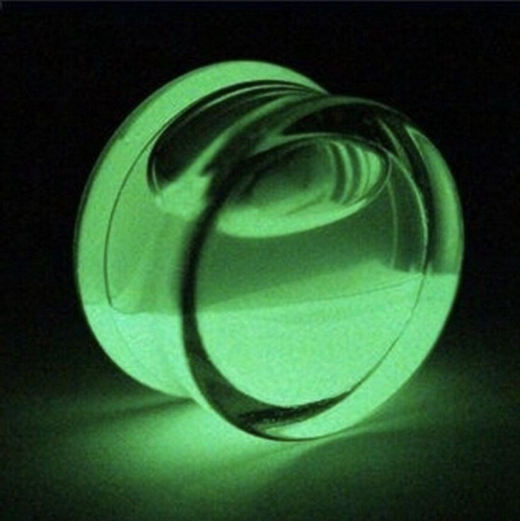 a close up of a green object in the dark