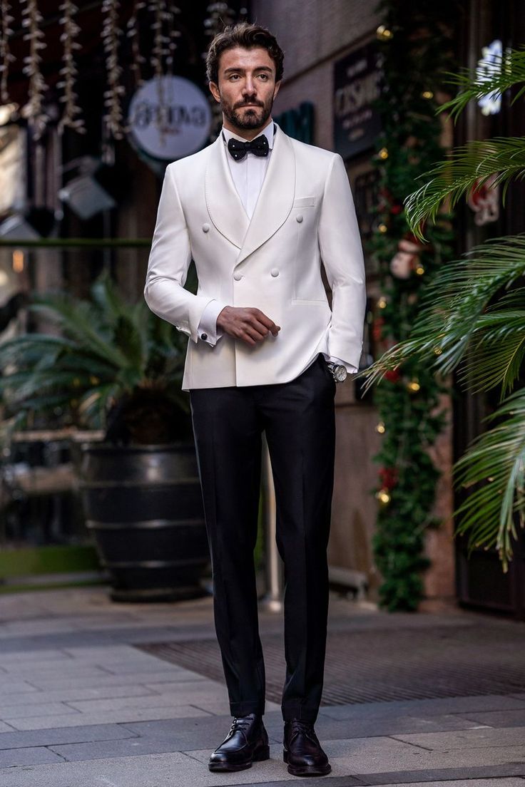 Flaunt your luxurious charm with the White Slim-Fit Tuxedo 3-Piece. The elegant white color and meticulously tailored fit offer a look of pure sophistication and class. Perfect for grand events and special occasions, this tuxedo guarantees you’ll make a stunning impression, exuding confidence and style.  #doublebreasted #whitetuxedo #tuxedo #suit #suits #slimfit #menstyle #menfashion #fashioninspo Classy Wedding Suits For Men, Off White Tuxedo Wedding, Men’s White Tuxedo, Modern Wedding Suits Men, Men’s Tuxedo, Designer Tuxedo For Men, White Double Breasted Suit Men, Formal Tuxedo For Men, Royal Men Outfit