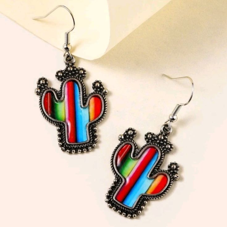 1 Pair Of Striped Multicolor Cactus Dangle Earrings Eardrop Length: 4.9 Cm Width: 2.3 Cm Tags: Bohemian, Boho, Hippie, Hippy, Beach, Retro Aztec, Vintage, 60s, 70s, Summer, Spring, Floral, Gypsy, Artistic, Art, Artsy, Fairycore, Fairy Core, Grunge, Festival, Desert, Mexican, Mexico, Desert, Deserts, Midwest Neon, Bright, Colorful, Multicolor, California, California, New Mexico, Tribal, Native American, Heritage, Symbol, Historic, Trending, Vertical Stripes, Western, West Coast, Westcoast, Colorf Cute Multicolor Jewelry With Ear Wire, Cute Multicolor Jewelry, Colorful Casual Jewelry For Festival, Retro Multicolor Metal Earrings, Multicolor Southwestern Summer Jewelry, Retro Multicolor Drop Earrings, Casual Multicolor Teardrop Earrings, Southwestern Style Earrings For Summer Festival, Southwestern Style Summer Festival Earrings