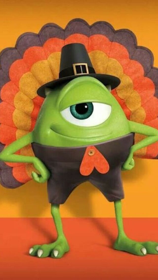 a green cartoon character wearing a black hat and holding a turkey shaped object in front of an orange background