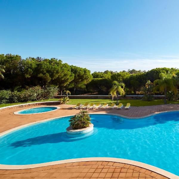 an empty swimming pool surrounded by trees