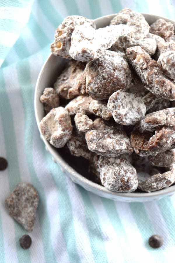 a white bowl filled with chocolate muddy dog treats on top of a blue and white towel