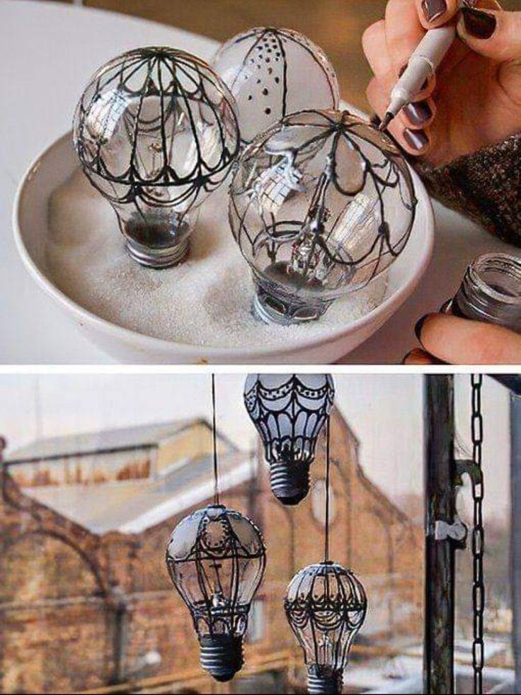 some glass balls are hanging from chains on a plate and one is being used as an ornament