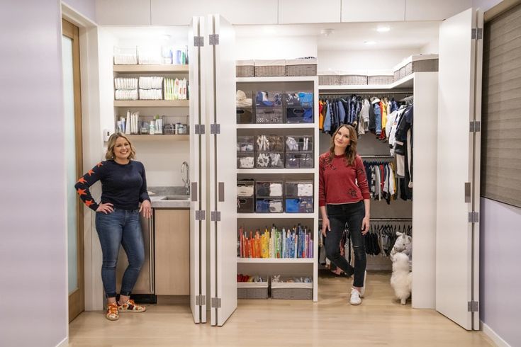 two women are standing in the closet next to each other