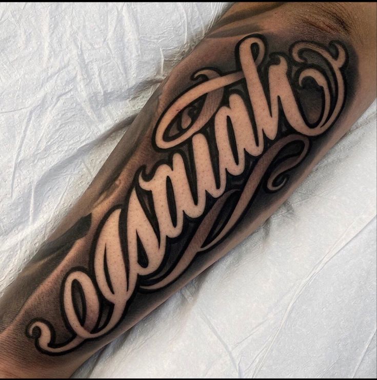 a man's arm with the word genius written in cursive writing on it