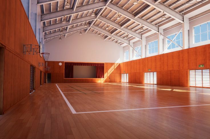 an empty gym with hard wood flooring and large windows on the side of the wall