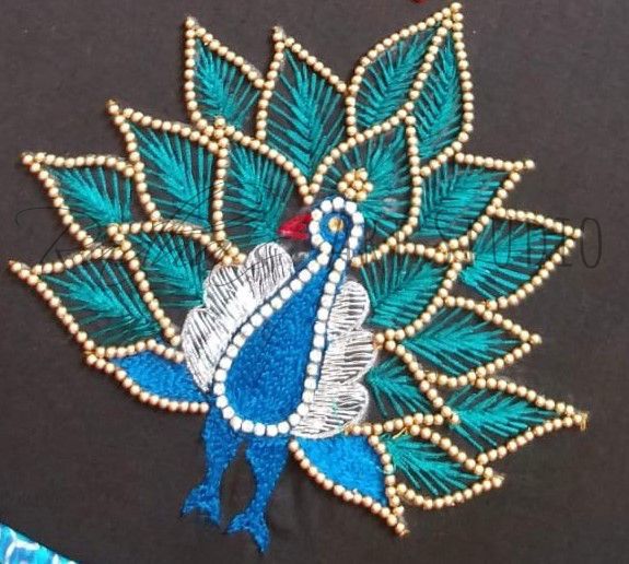 an embroidered peacock on a black shirt with blue and green feathers, beaded in beads