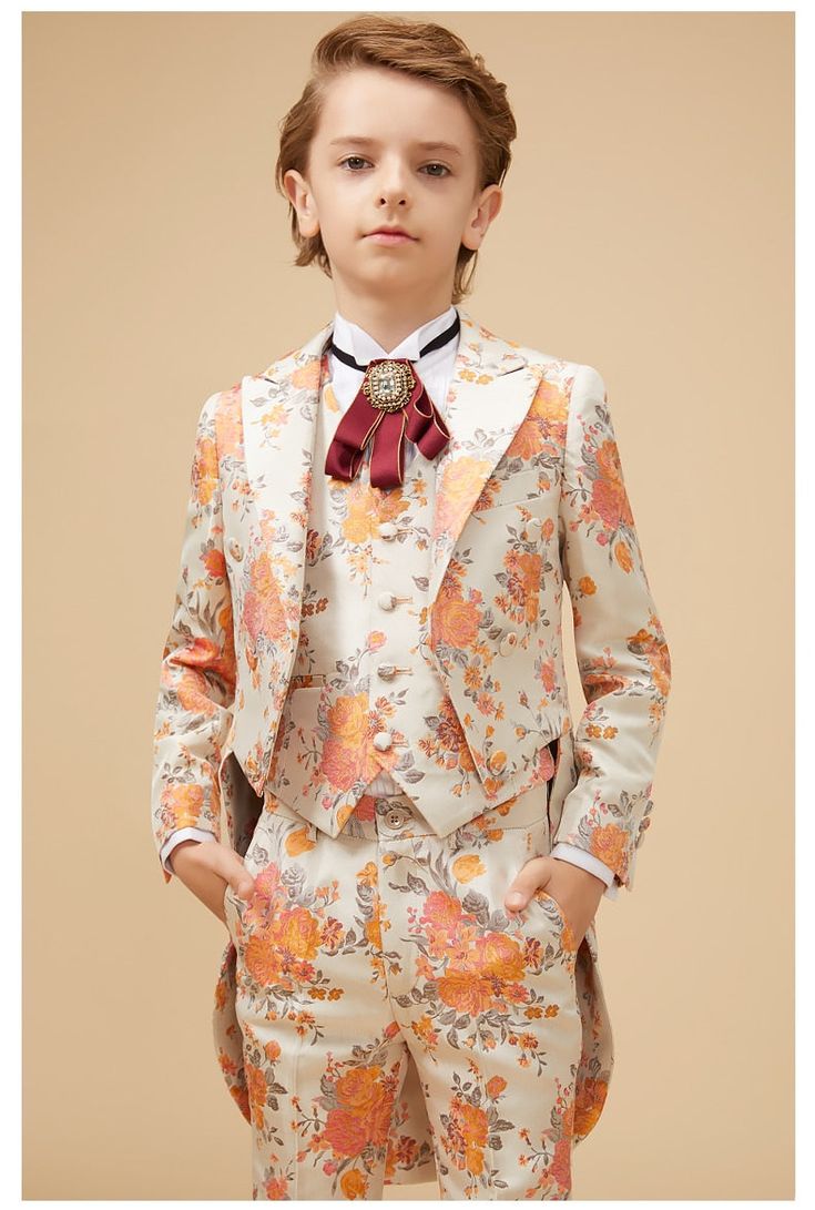 Traditional styling paired with modern chic. This 5-piece Floral Print Ensemble is both classical and flared with boulevardier adornments. Whether you find your family at a spring wedding reception or an exclusive summer banquet, your Petit Gentleman will be the center of attention. Our elegant Floral Print Ensemble comes with the Bouquet floral jacket, trousers, and matching vest, along with a brilliant white shirt that displays the signature royal red Victorian necktie. All 5 pieces are tailor Spring Formal Fitted Three-piece Suit, Tailored Spring Party Tuxedo, Elegant Fitted Three-piece Suit For Spring, Fitted Three-piece Suit For Summer Formal, Elegant Fitted Spring Tuxedo, Fitted Three-piece Suit For Summer Formal Events, Fitted Three-piece Summer Suit For Formal Occasions, Summer Fitted Three-piece Suit For Formal Occasions, Fitted Summer Three-piece Suit For Formal Occasions