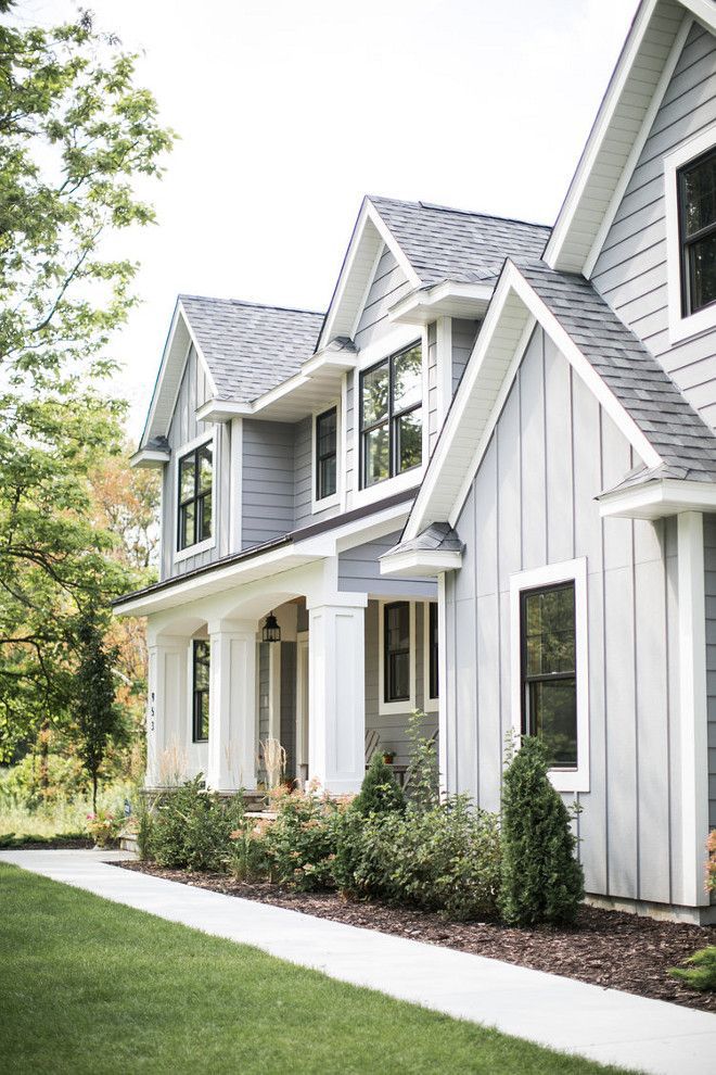 a gray house with white trim and windows