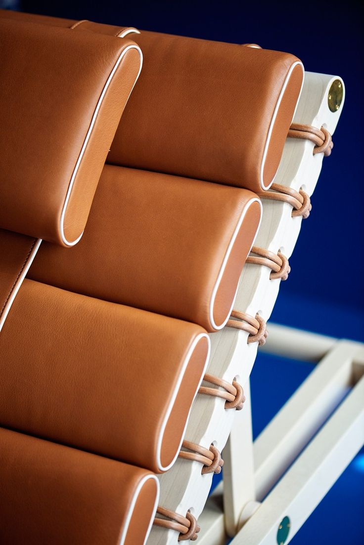 four brown leather chairs stacked on top of each other