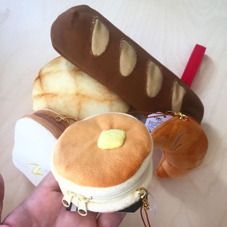 a hand holding an ice cream sundae, hot dog and waffle sandwich