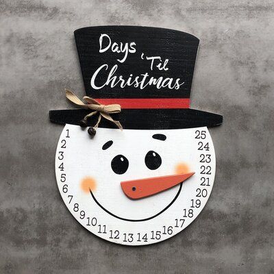 a clock with a snowman's hat on it and days to christmas written on the face