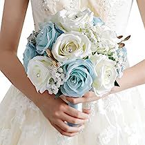 a bride holding a bouquet of white and blue flowers