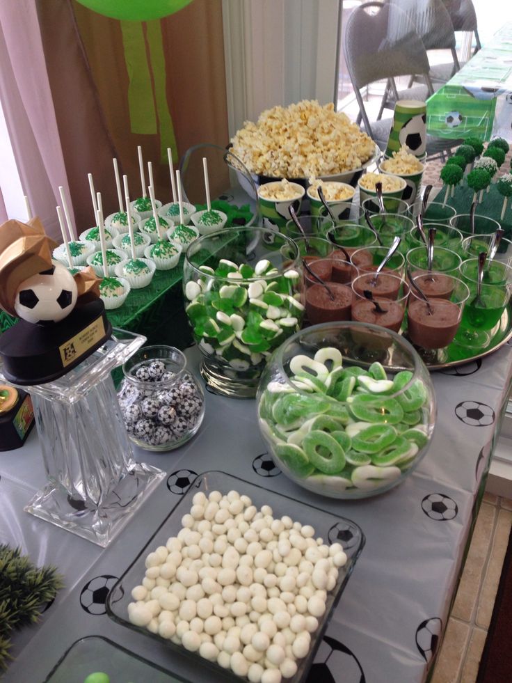 a table topped with lots of green and white desserts