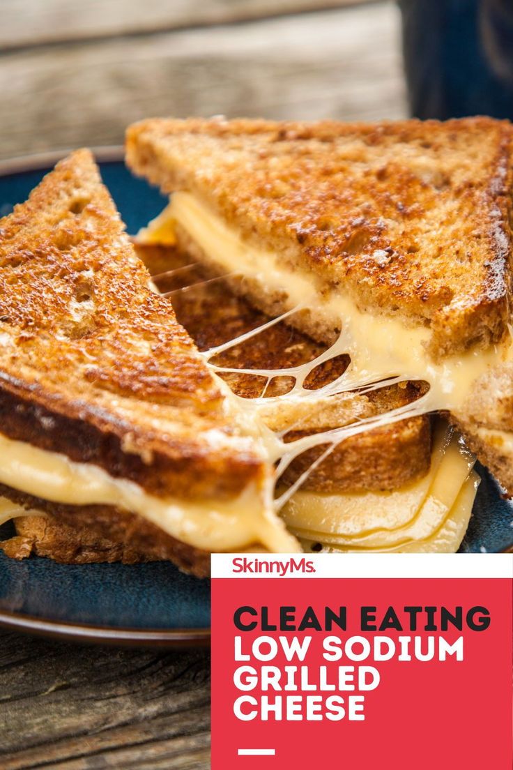 a grilled cheese sandwich on a blue plate with the words clean eating low sodium grilled cheese