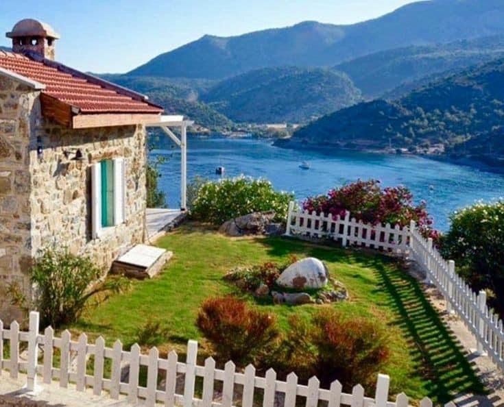 an image of a house with the word interest on it's front lawn and mountains in the background