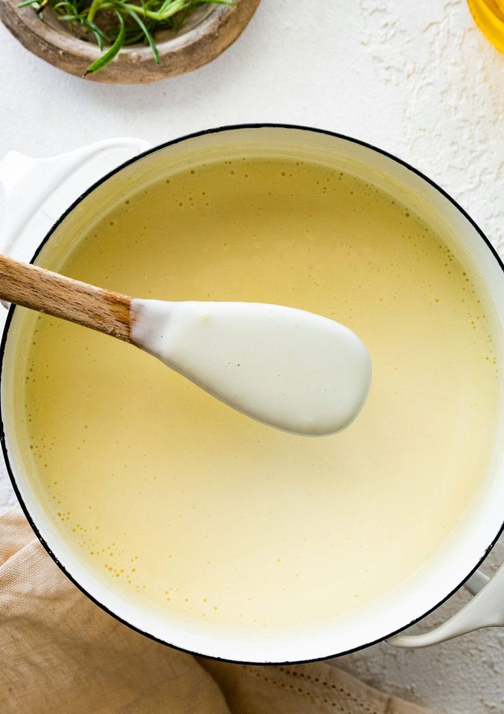 a wooden spoon in a pot filled with liquid