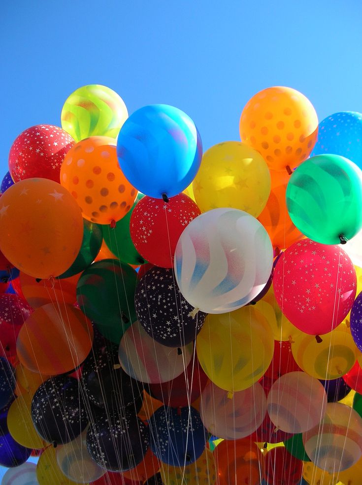 a bunch of balloons that are in the air