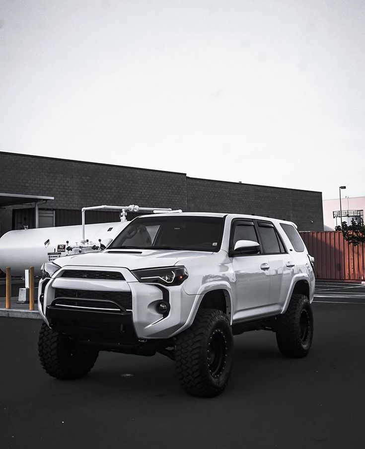 a white truck parked in front of a building