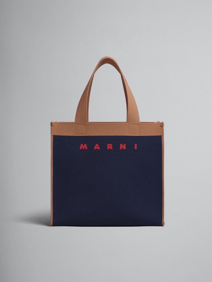 Shopping bag in knitted fabric. Medium size. Colourblock design with signature Marni logo on the front. Carried in the hand. Detachable vegan leather zipped pouch. Everyday Top Handle Bag With Embroidered Logo, Top Handle Bag With Embroidered Logo, Designer Canvas Bags With Embroidered Logo, Modern Rectangular Bag With Embroidered Logo, Designer Tote Bag With Embroidered Logo, Luxury Everyday Bag With Embroidered Logo, Leather Bags With Embroidered Logo For Daily Use, Embroidered Logo Coated Canvas Tote Bag, Blue Canvas Bag With Embroidered Logo