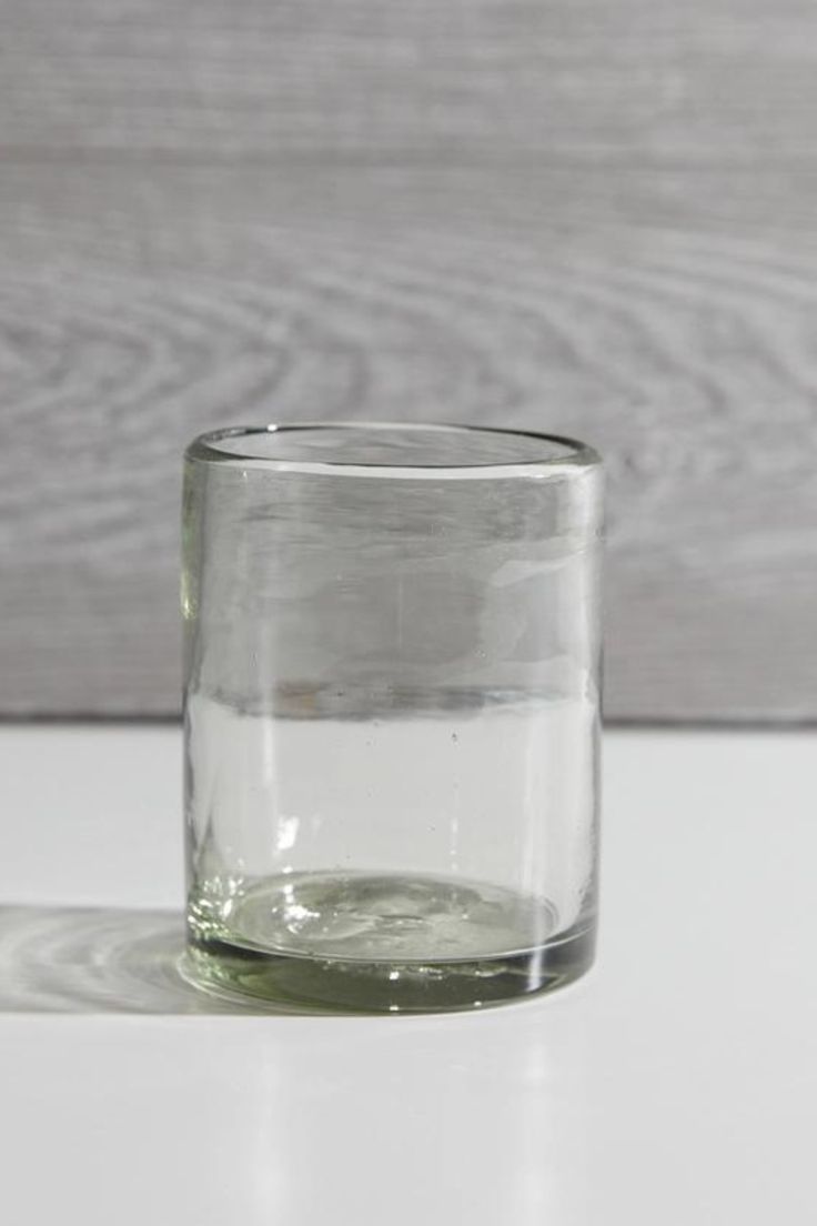 a glass filled with water sitting on top of a table