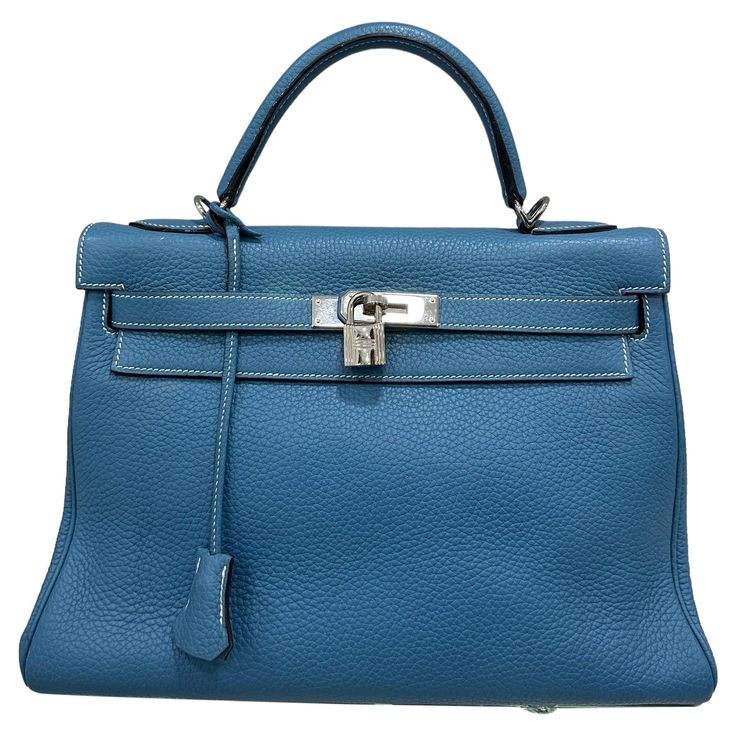 Bag by Hermès, Kelly model, size 32, made in Clemence leather, soft and textured to the touch, in the Blue Izmir colorway, with silver hardware. Equipped with the classic flap with interlocking closure with horizontal band, padlock and keys. Equipped with a central handle for carrying by hand and hooks with a thin removable leather shoulder strap. There are several internal pockets. Year of production 2006. It is in excellent condition. Hermes Blue, Structured Shoulder, Hermes Kelly Bag, Kelly Bag, Hermes Handbags, Classic Flap, Handle Bag, Silver Hardware, Fashion Handbags