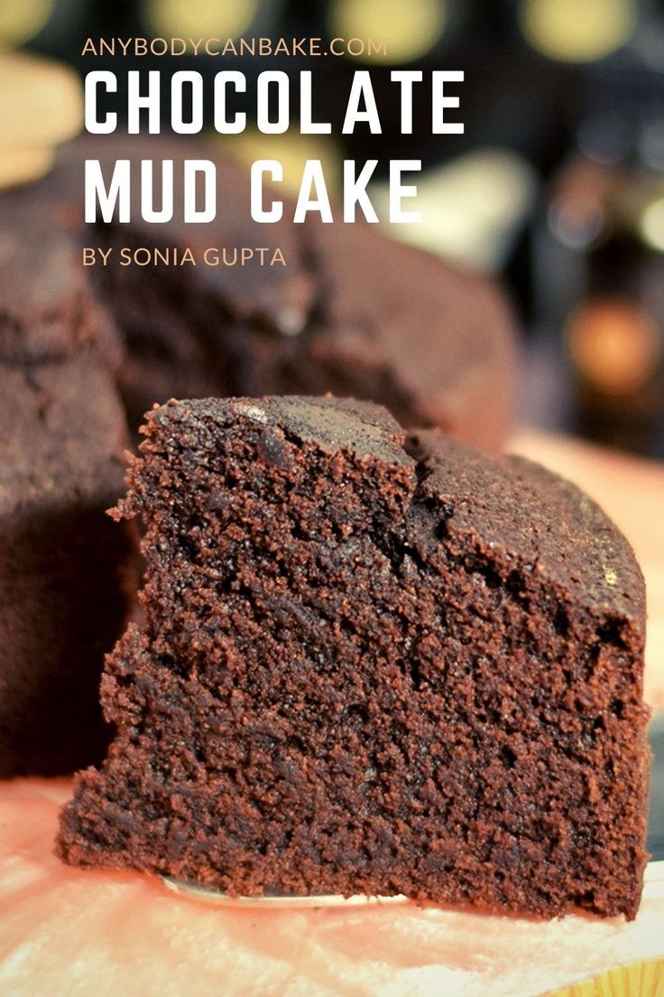 chocolate mud cake is cut in half on a cutting board with the title above it