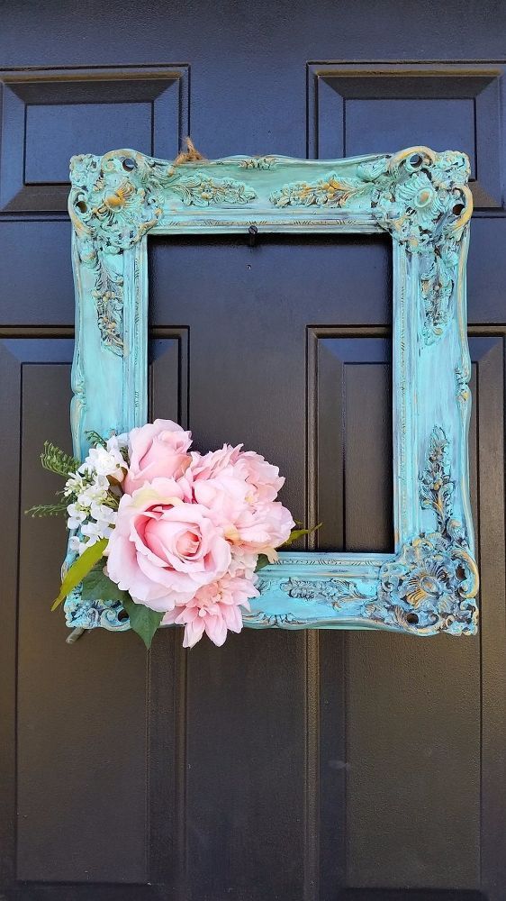 a blue frame with pink flowers on the front door