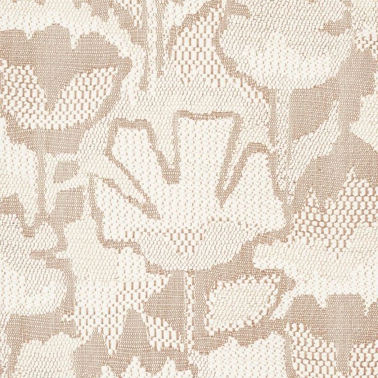 an upholstered fabric with flowers and leaves in white, beige and brown colors