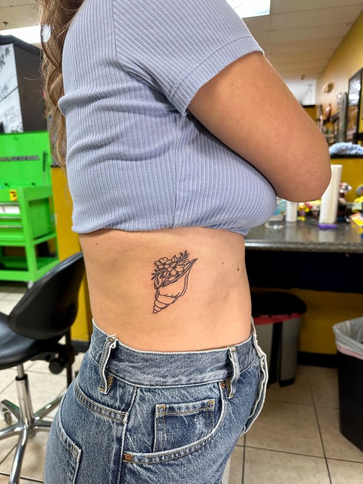 flowers, conch shell, beach, tattoo Shell Tattoo With Flowers, Conch Shell Tattoo, Shell Tattoo, Tattoo With Flowers, Hawaii Tattoos, Shell Tattoos, Shell Flowers, Ocean Tattoos, Beach Tattoo