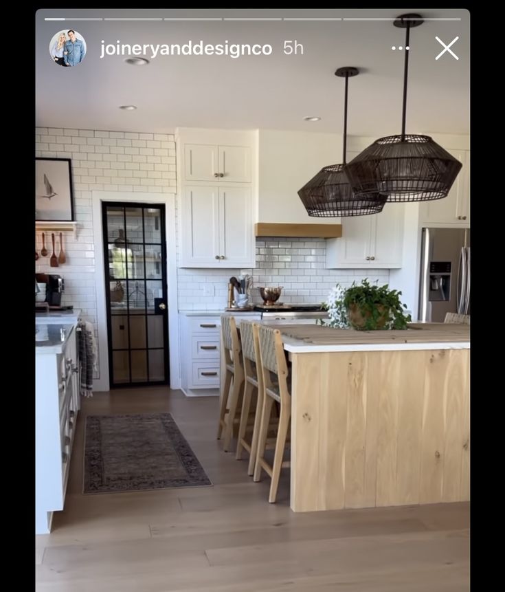 a kitchen with white cabinets and an island