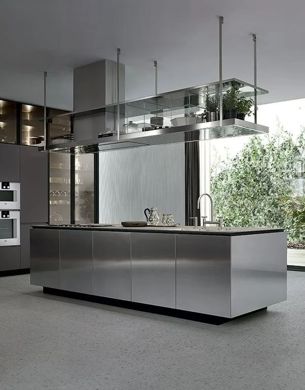 a modern kitchen with stainless steel appliances and cabinets