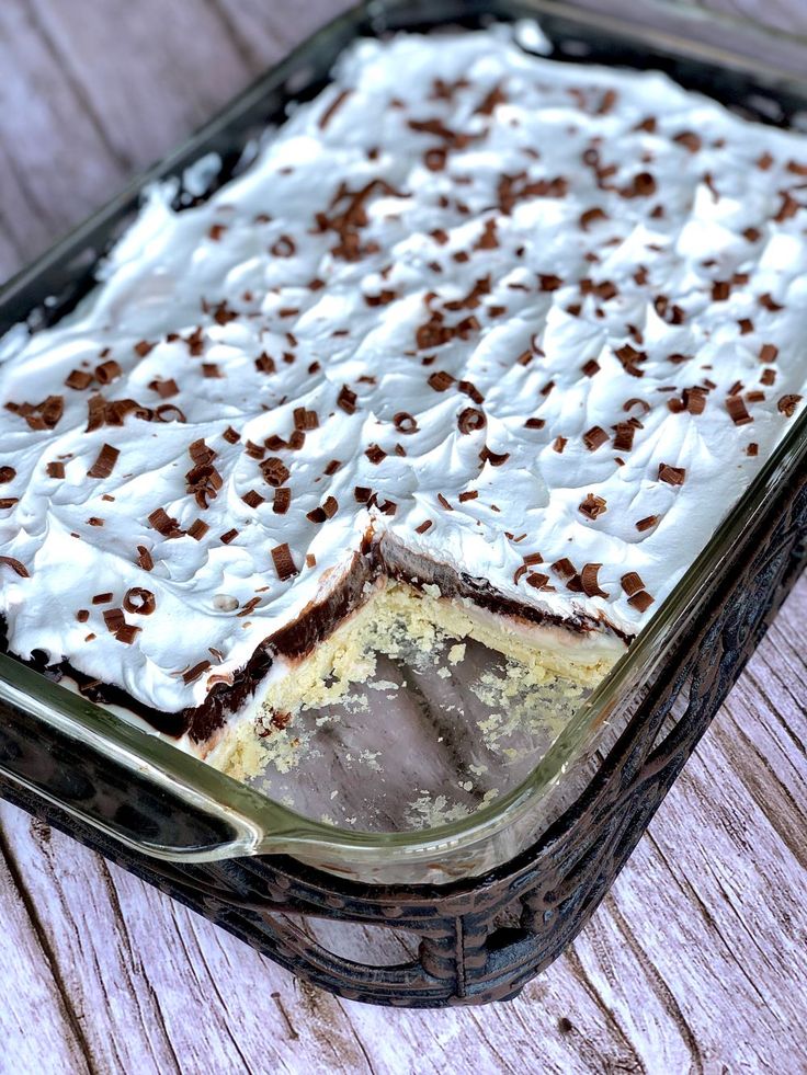 a cake in a glass dish on a wooden table