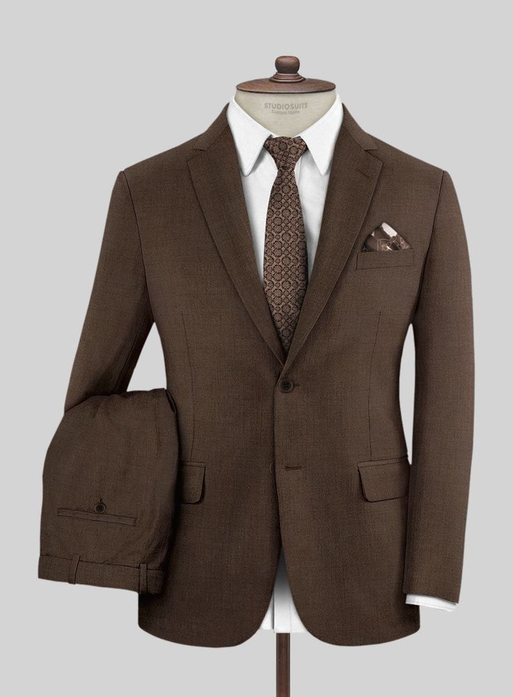 Simple but effective, the Worsted Brown Wool Suit offers an on-trend take on classic dressing. Crafted from a wool blend, the fabric comes with a brown hue that will help you focus on the special moments and be a great addition to your wardrobe.   Look Includes  Worsted Brown Wool Fabric  Two Button Jacket Style  Notch Lapel  Horn Brown Buttons  Single Vent  Three Cuff Buttons  Two Welted Pocket on Trousers   You can change the look during customization if required.  Lining: Viscose; Dry Clean. Brown Blazer With Concealed Placket For Business, Tailored Brown Suit With Long Sleeves, Classic Suits In Suiting Fabric For Fall, Brown Long Sleeve Office Suits, Formal Brown Blazer With Concealed Placket, Fitted Brown Blazer With Pressed Crease, Elegant Brown Blazer For Semi-formal Occasions, Brown Wool Single Breasted Suit, Brown Suits With Concealed Placket For Workwear