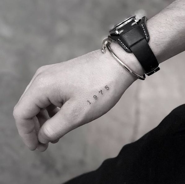 a person's wrist with the word hope tattooed on it, in black and white